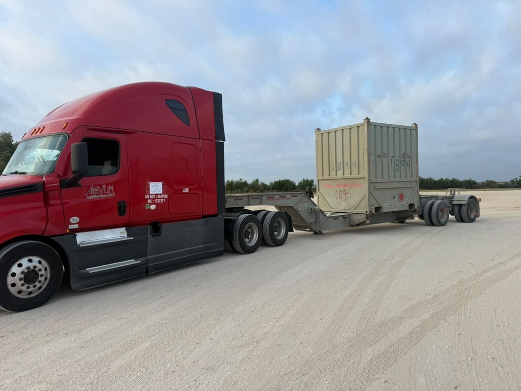 Oilfield sandbox hauling trucks at fracking site